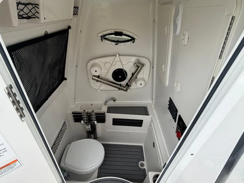 Slide: The Image of 2025 Sailfish 272 CC boat interior with compact bathroom and storage features. - 21