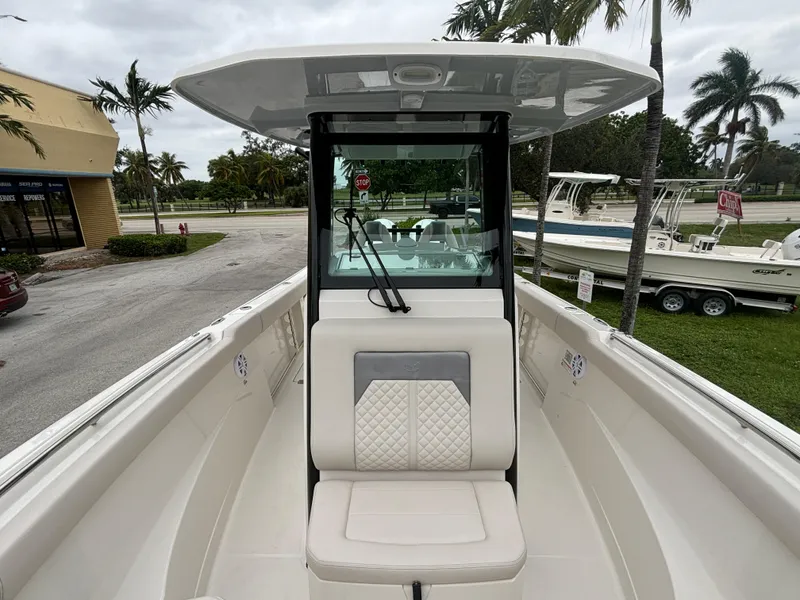 Slide: The Image of 2025 Sailfish 272 CC boat with center console and seating, parked outdoors. - 22