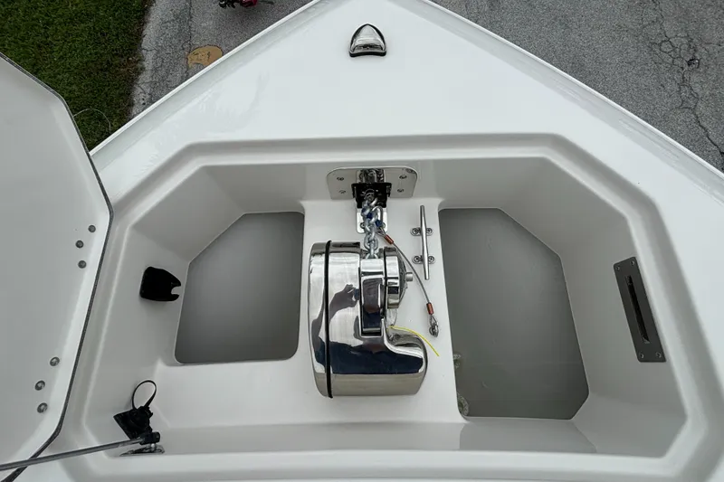 Slide: The Image of 2025 Sailfish 272 CC boat anchor compartment with winch and storage. - 27