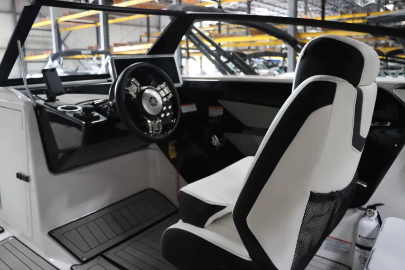 Slide: The Image of Interior of 2025 Yamaha Boats 222SD, featuring sleek steering and modern seating. - 15