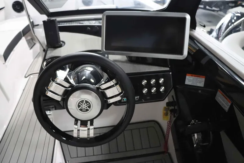 Slide: The Image of 2025 Yamaha Boats 222SD dashboard with steering wheel and touchscreen display. - 17