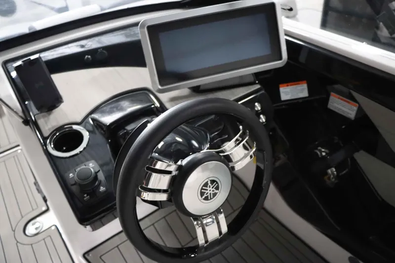 Slide: The Image of 2025 Yamaha Boats 222SD dashboard with steering wheel and touchscreen display. - 18