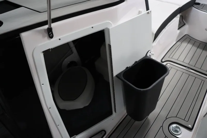 Slide: The Image of 2025 Yamaha Boats 222SD interior with storage compartment and trash bin. - 19