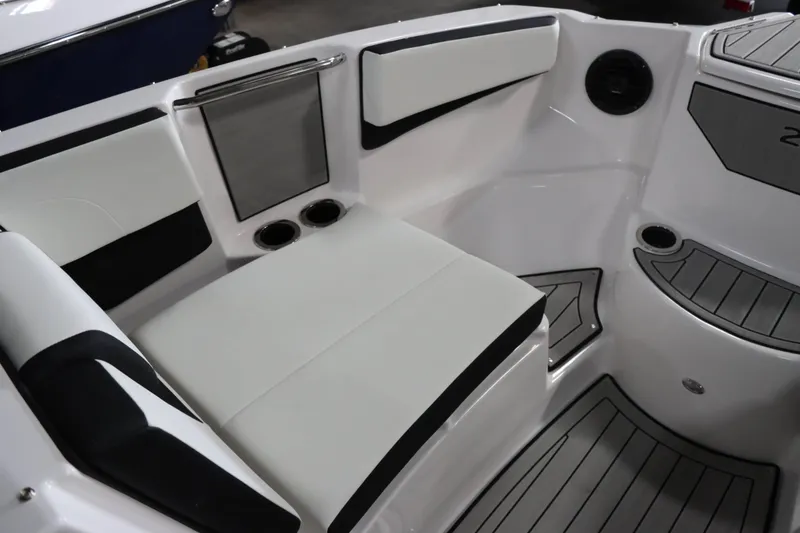 Slide: The Image of 2025 Yamaha Boats 222SD interior seating with cup holders and sleek design. - 24