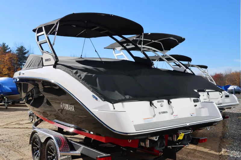 Slide: The Image of 2025 Yamaha Boats 222SD on trailer, covered, outdoors under clear blue sky. - 3