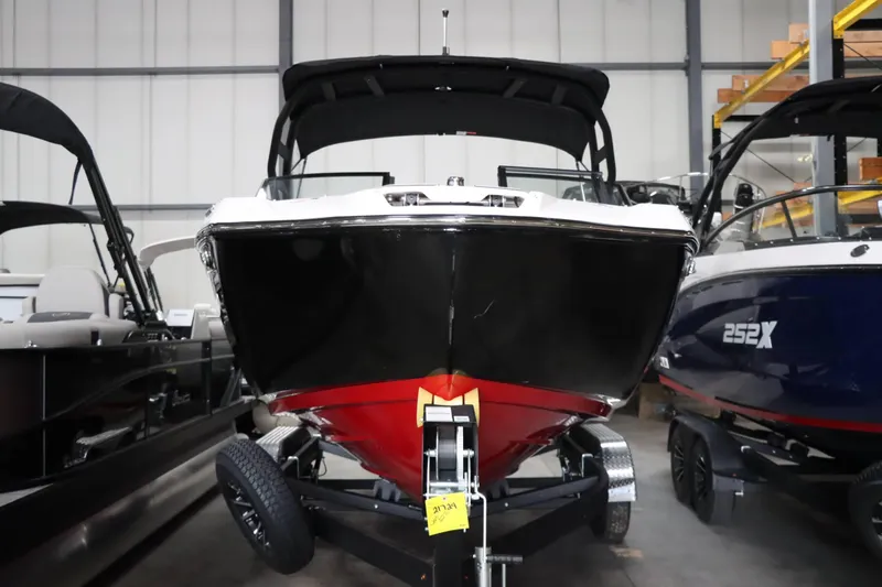 Slide: The Image of 2025 Yamaha Boats 222SD in showroom, front view, black and red hull. - 7