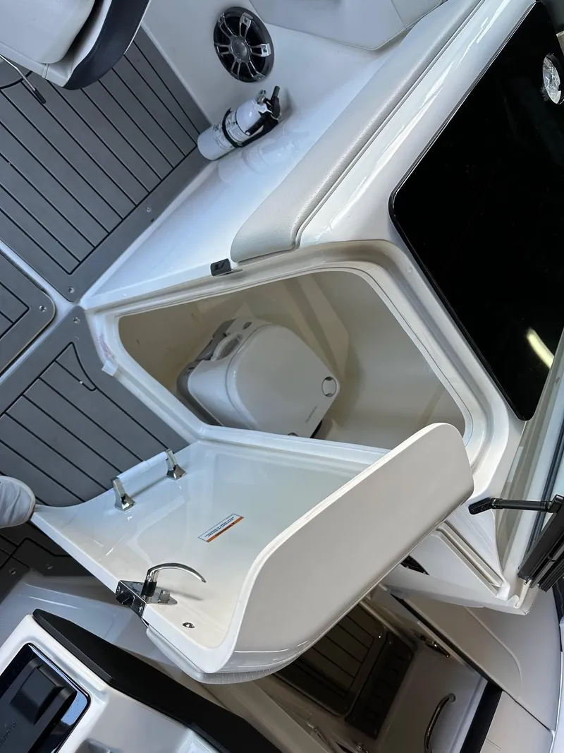 Slide: The Image of 2022 Sea Ray 230SPX boat interior with compact bathroom and sink. - 10