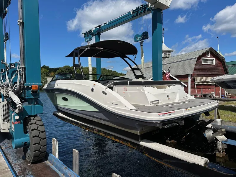Slide: The Image of 2022 Sea Ray 230SPX boat on lift at marina, clear sky background. - 3