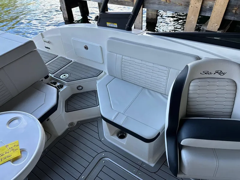 Slide: The Image of 2022 Sea Ray 230SPX boat interior with white seating and gray flooring. - 6