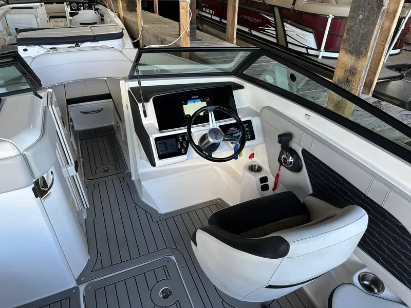 Slide: The Image of 2022 Sea Ray 230SPX boat interior with modern dashboard and seating. - 8