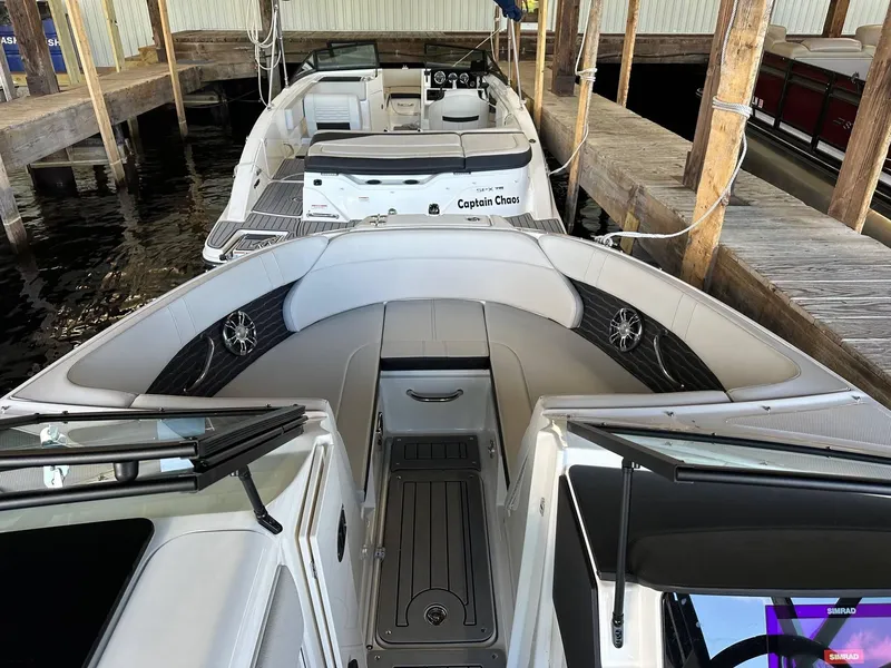 Slide: The Image of 2022 Sea Ray 230SPX boat docked, featuring spacious seating and modern design. - 9