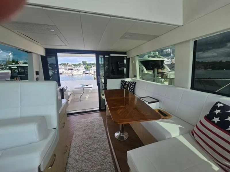 Slide: The Image of Luxurious interior of 2024 Regal 42 Fly yacht with elegant seating and scenic marina view. - 4