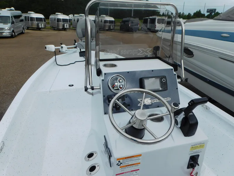 Slide: The Image of 2025 Xpress H21 Bay boat dashboard with steering wheel and controls. - 12