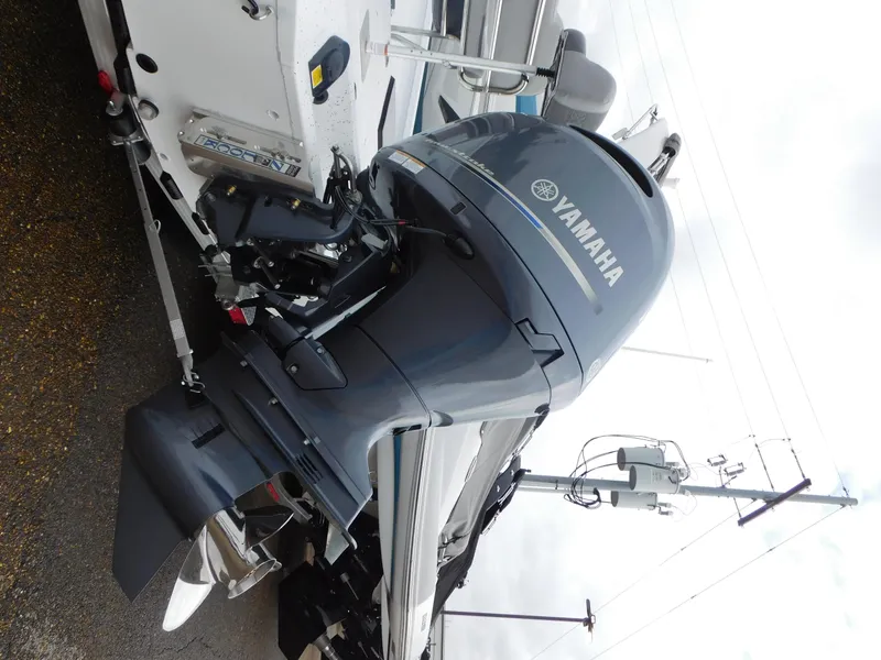 Slide: The Image of 2025 Xpress H21 Bay boat with Yamaha outboard motor, side view. - 14