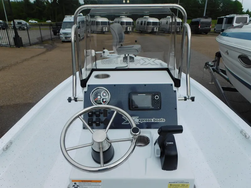 Slide: The Image of 2025 Xpress H21 Bay boat dashboard with steering wheel and controls. - 3