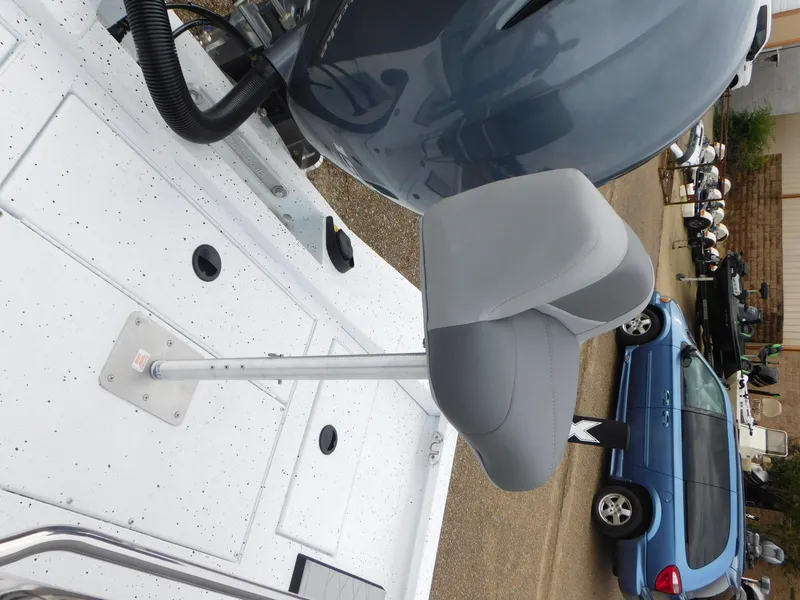 Slide: The Image of 2025 Xpress H21 Bay boat seat and motor detail in a parking lot. - 9