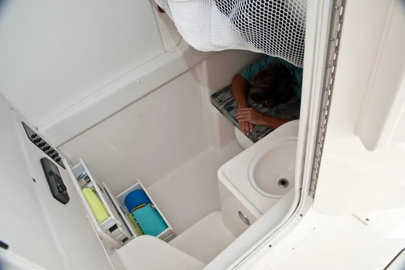 Slide: The Image of 2015 Century 3200 Center Console cabin interior with storage and seating area. - 11