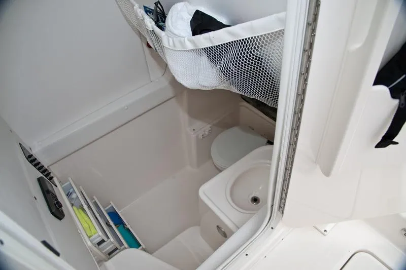 Slide: The Image of 2015 Century 3200 Center Console boat interior with compact bathroom amenities. - 12