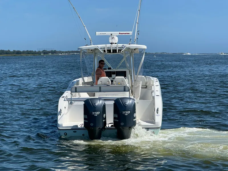 Slide: The Image of 2015 Century 3200 Center Console boat on water, dual engines, clear sky. - 23