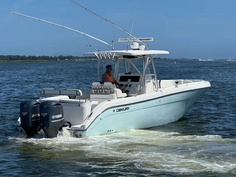Slide: The Image of 2015 Century 3200 Center Console boat cruising on open water with dual Yamaha engines. - 27