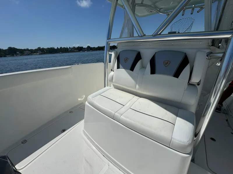 Slide: The Image of 2015 Century 3200 Center Console boat interior with white seating, on a sunny day. - 28