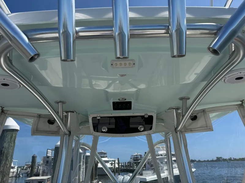 Slide: The Image of 2015 Century 3200 Center Console boat, view of T-top and rod holders. - 29