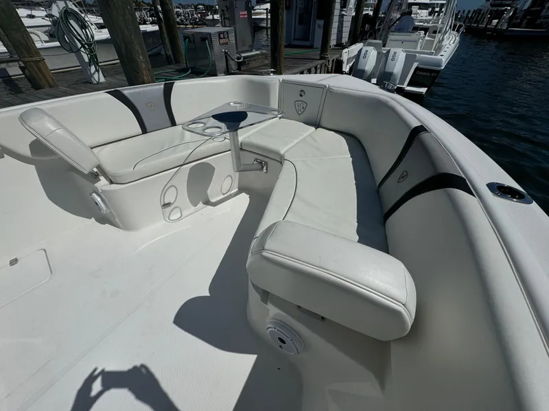 Slide: The Image of 2015 Century 3200 Center Console boat with white seating at a marina. - 32