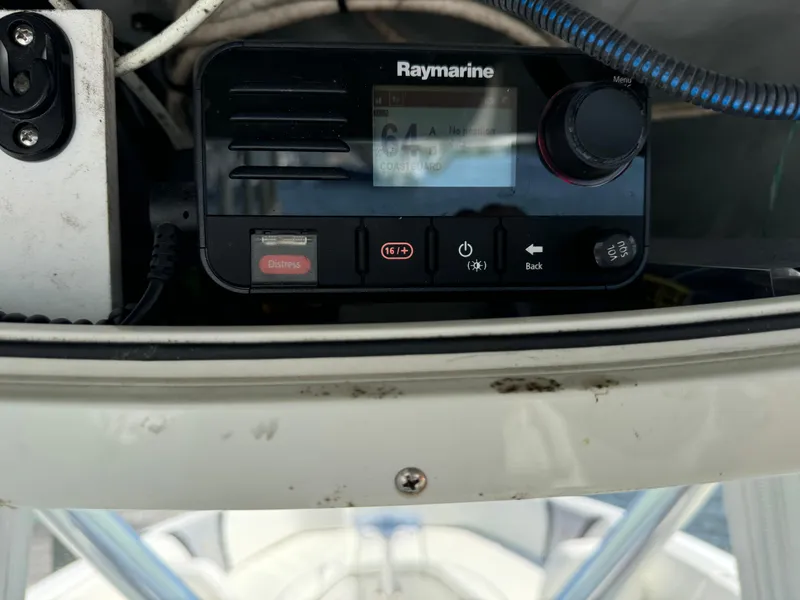 Slide: The Image of Raymarine marine radio on 2015 Century 3200 Center Console boat dashboard. - 34