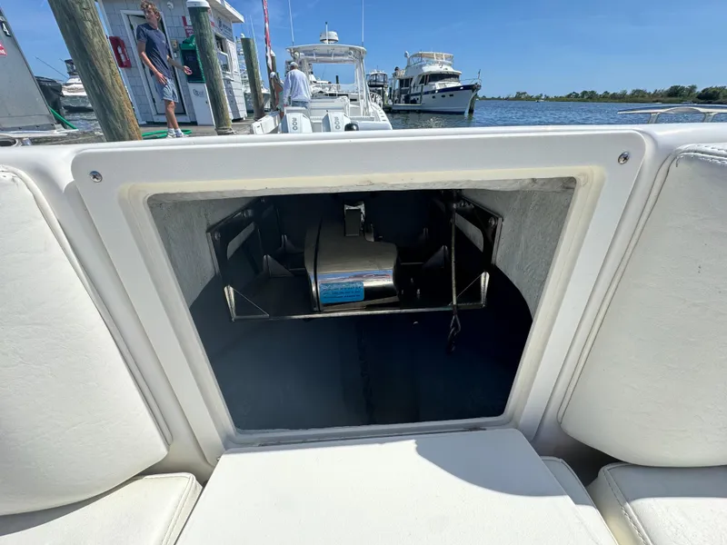 Slide: The Image of Century 3200 Center Console 2015 boat storage compartment at marina dock. - 35