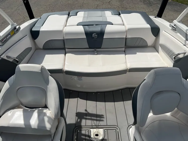 Slide: The Image of 2021 Chaparral 21 Surf boat interior with white and gray seating. - 2