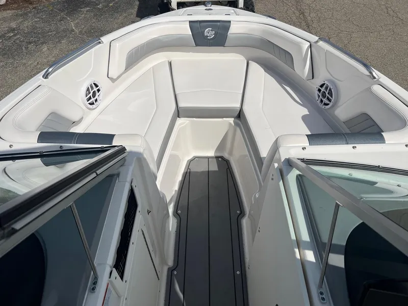 Slide: The Image of 2021 Chaparral 21 Surf boat interior with white seating and speakers. - 3