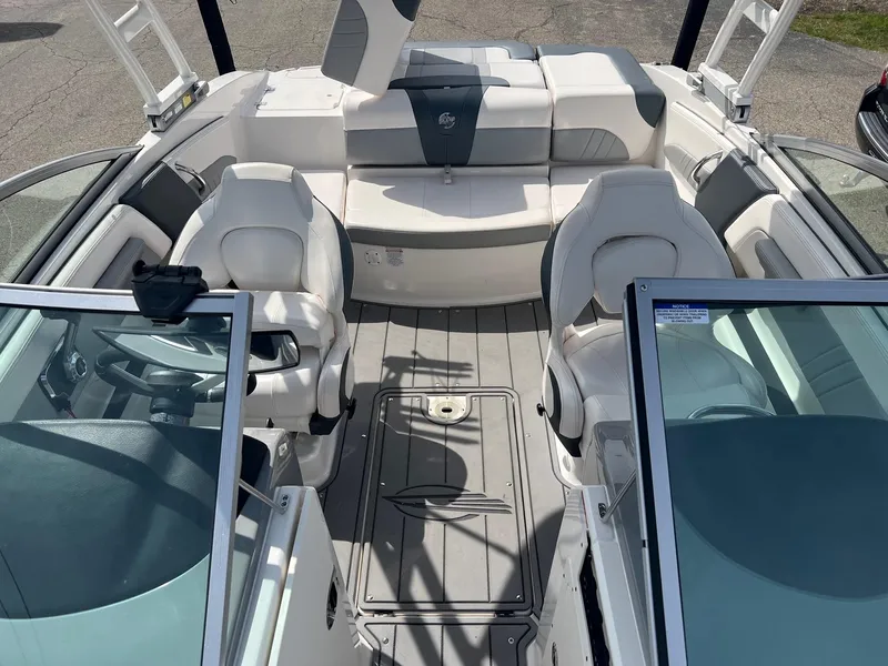 Slide: The Image of 2021 Chaparral 21 Surf boat interior with white seating and modern design. - 4