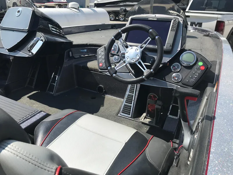 Slide: The Image of 2017 Ranger Z520 Comanche boat cockpit with steering wheel and control panel. - 17