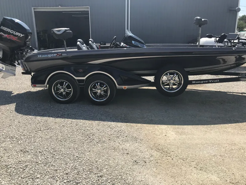 Slide: The Image of 2017 Ranger Z520 Comanche boat with Mercury engine, parked on gravel. - 21
