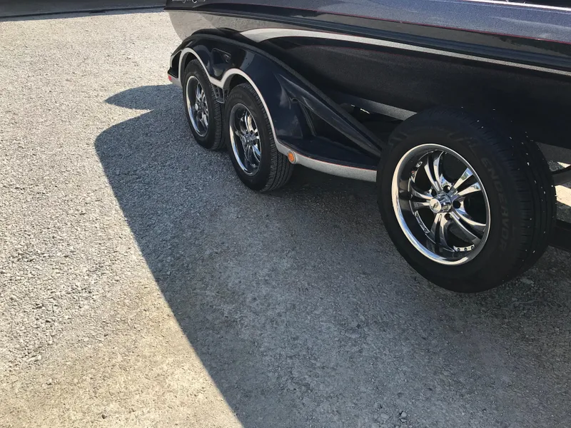 Slide: The Image of 2017 Ranger Z520 Comanche boat trailer with shiny chrome wheels on a sunny day. - 26