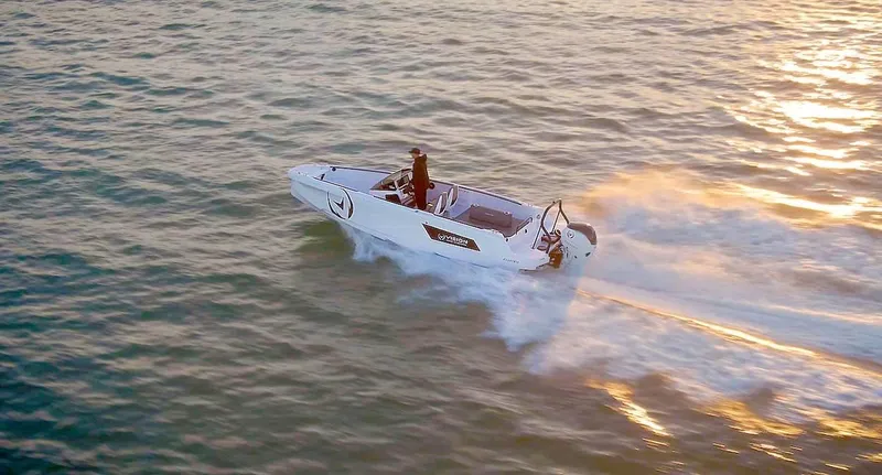 Slide: The Image of 2021 Axopar Spyder 22 speeding on open water at sunset. - 1
