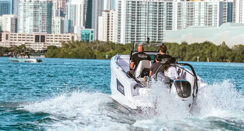 Slide: The Image of Axopar Spyder 22 boat cruising in urban waterfront, 2021 model. - 5