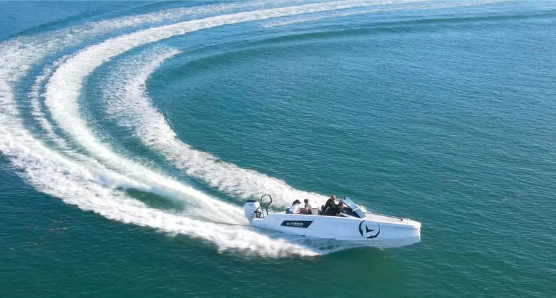 Slide: The Image of 2021 Axopar Spyder 22 speeding on open water, creating dynamic wake patterns. - 6