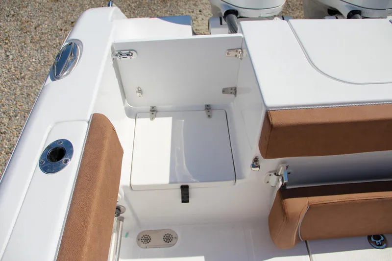 Slide: The Image of 2025 Sea Hunt Gamefish 25 boat interior with storage compartment and cushioned seating. - 15