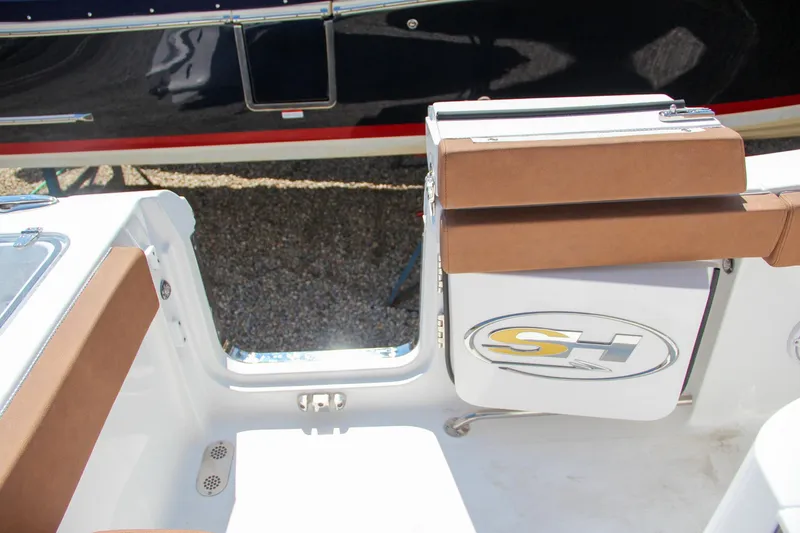 Slide: The Image of 2025 Sea Hunt Gamefish 25 boat interior with brown seating and SH logo. - 19