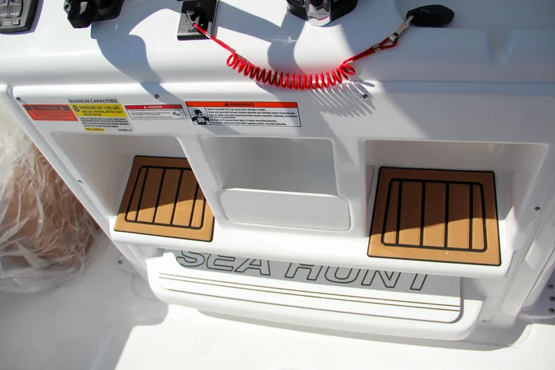 Slide: The Image of Sea Hunt Gamefish 25 boat console with safety features and branding, 2025 model. - 24
