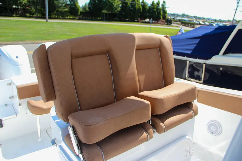 Slide: The Image of 2025 Sea Hunt Gamefish 25 boat seats, brown upholstery, outdoor setting. - 25