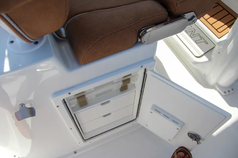 Slide: The Image of 2025 Sea Hunt Gamefish 25 boat interior with storage compartment and cushioned seating. - 28