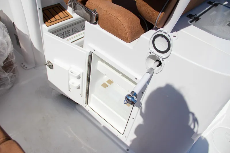 Slide: The Image of 2025 Sea Hunt Gamefish 25 boat interior with storage compartment and rod holder. - 30