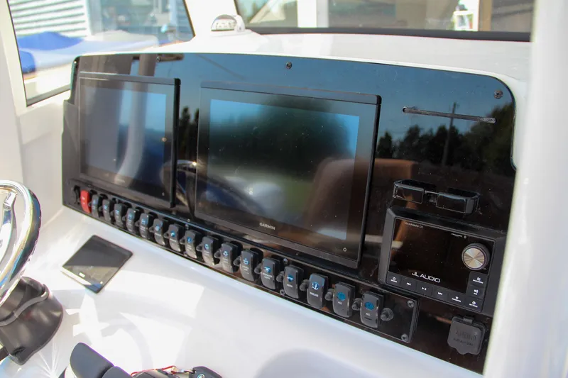 Slide: The Image of Dashboard of 2025 Sea Hunt Gamefish 25 with dual screens and control panel. - 32
