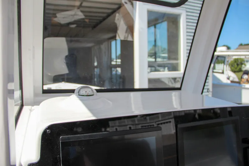 Slide: The Image of Interior view of 2025 Sea Hunt Gamefish 25 boat cockpit with navigation equipment. - 35