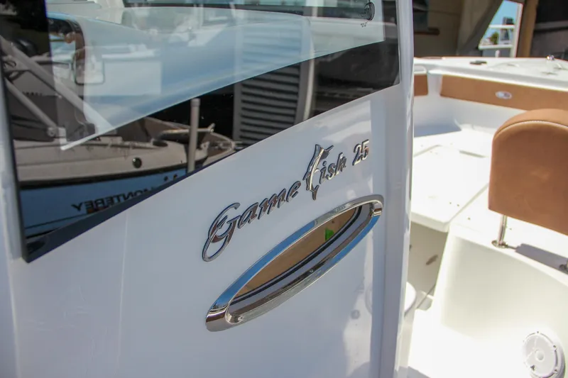 Slide: The Image of 2025 Sea Hunt Gamefish 25 boat, close-up of logo and interior details. - 37