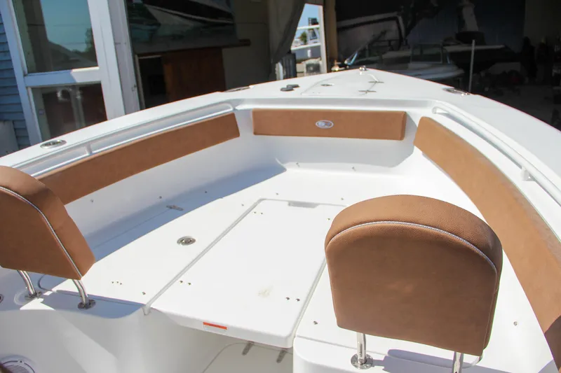 Slide: The Image of 2025 Sea Hunt Gamefish 25 boat interior with cushioned seating and spacious deck. - 38