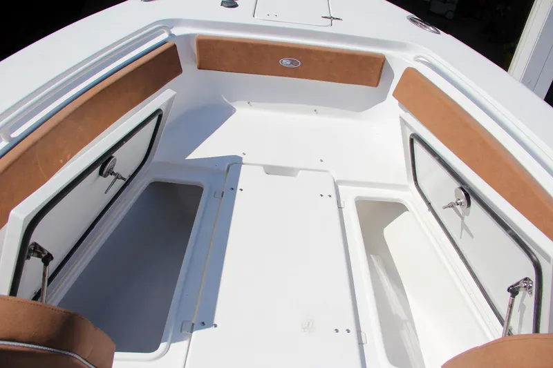 Slide: The Image of 2025 Sea Hunt Gamefish 25 boat interior with storage compartments and cushioned seating. - 39