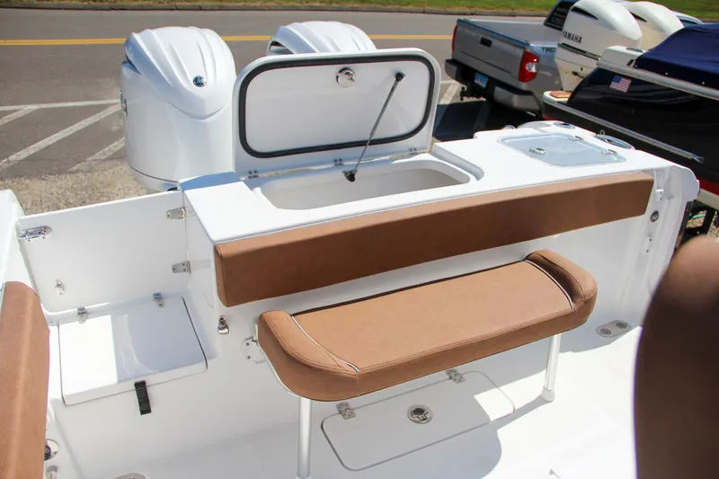 Slide: The Image of 2025 Sea Hunt Gamefish 25 boat interior with brown seating and storage compartments. - 4